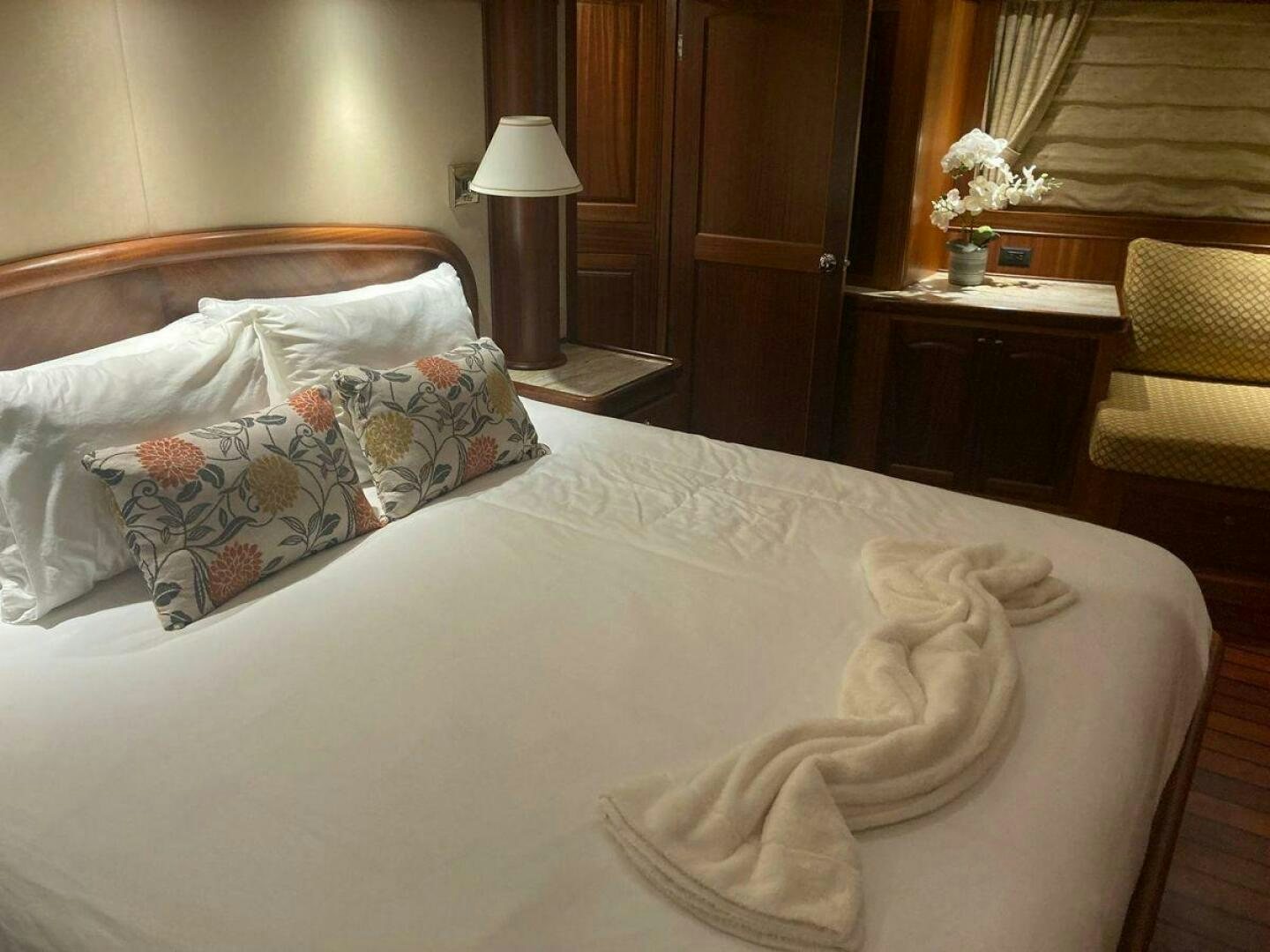 a bed with white sheets and pillows aboard ALLSEAS Yacht for Sale