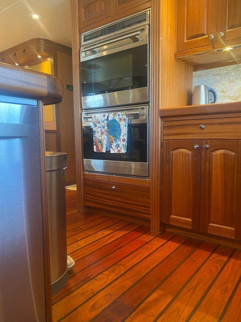 a kitchen with wooden cabinets aboard ALLSEAS Yacht for Sale