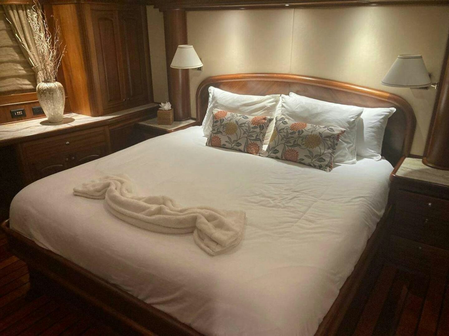 a bed with a white sheet and pillows aboard ALLSEAS Yacht for Sale
