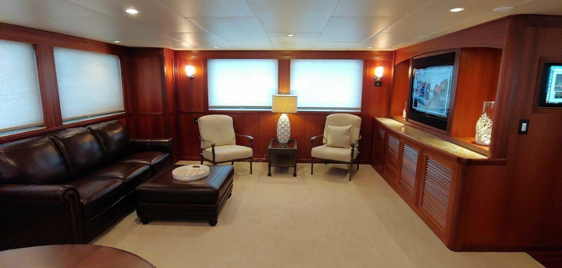a living room with leather couches and a television aboard ALLSEAS Yacht for Sale