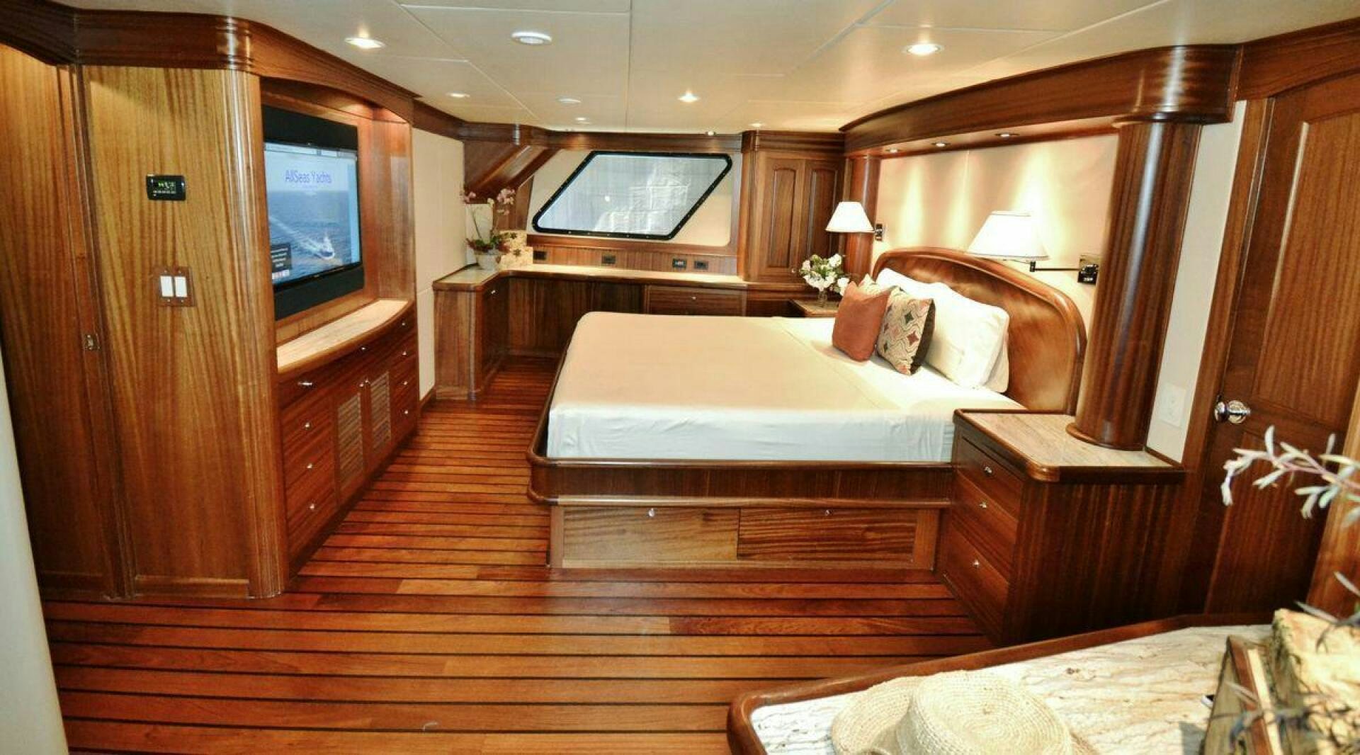 a room with a bed and a television aboard ALLSEAS Yacht for Sale