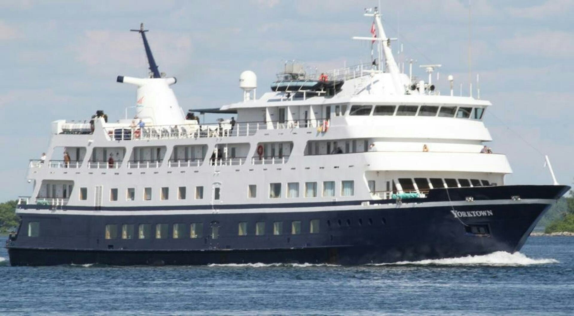 a large boat on the water aboard AMERICANA Yacht for Sale