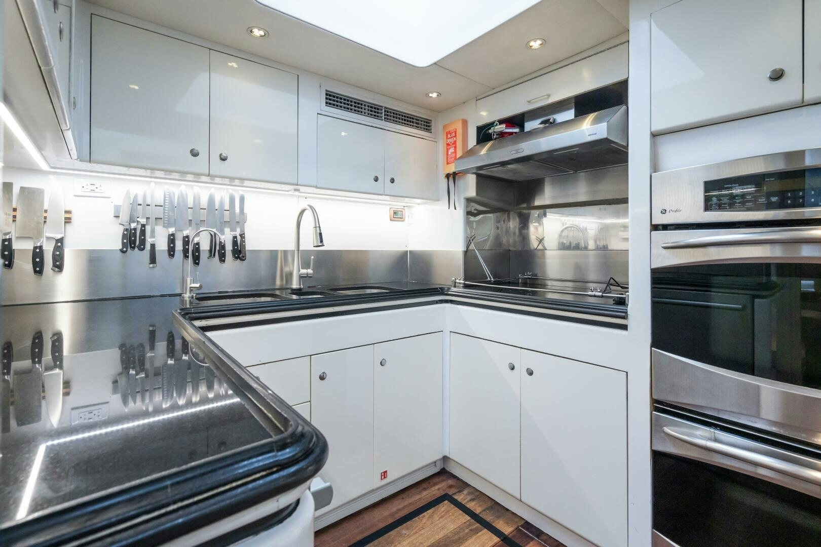 a kitchen with white cabinets aboard SEAQUELL Yacht for Sale