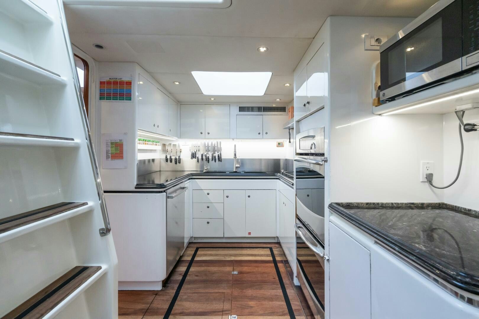 a kitchen with white cabinets aboard SEAQUELL Yacht for Sale