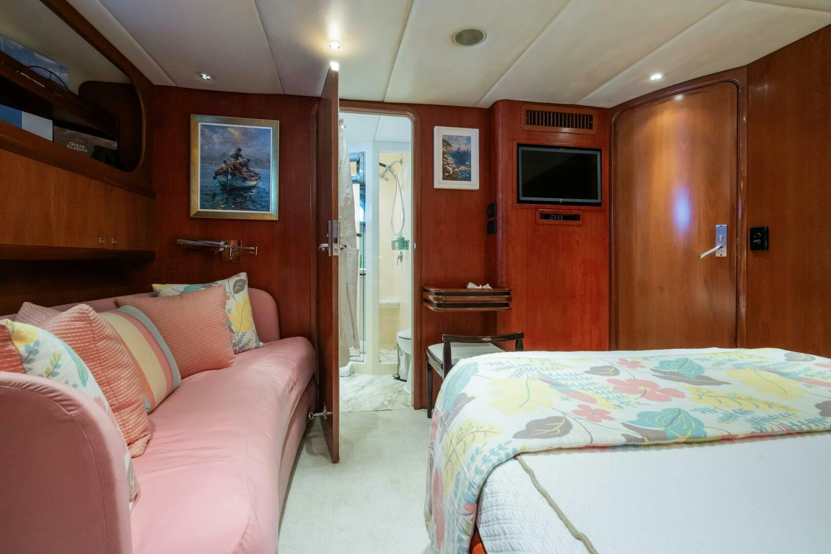 a bedroom with a bed and a television aboard SEAQUELL Yacht for Sale
