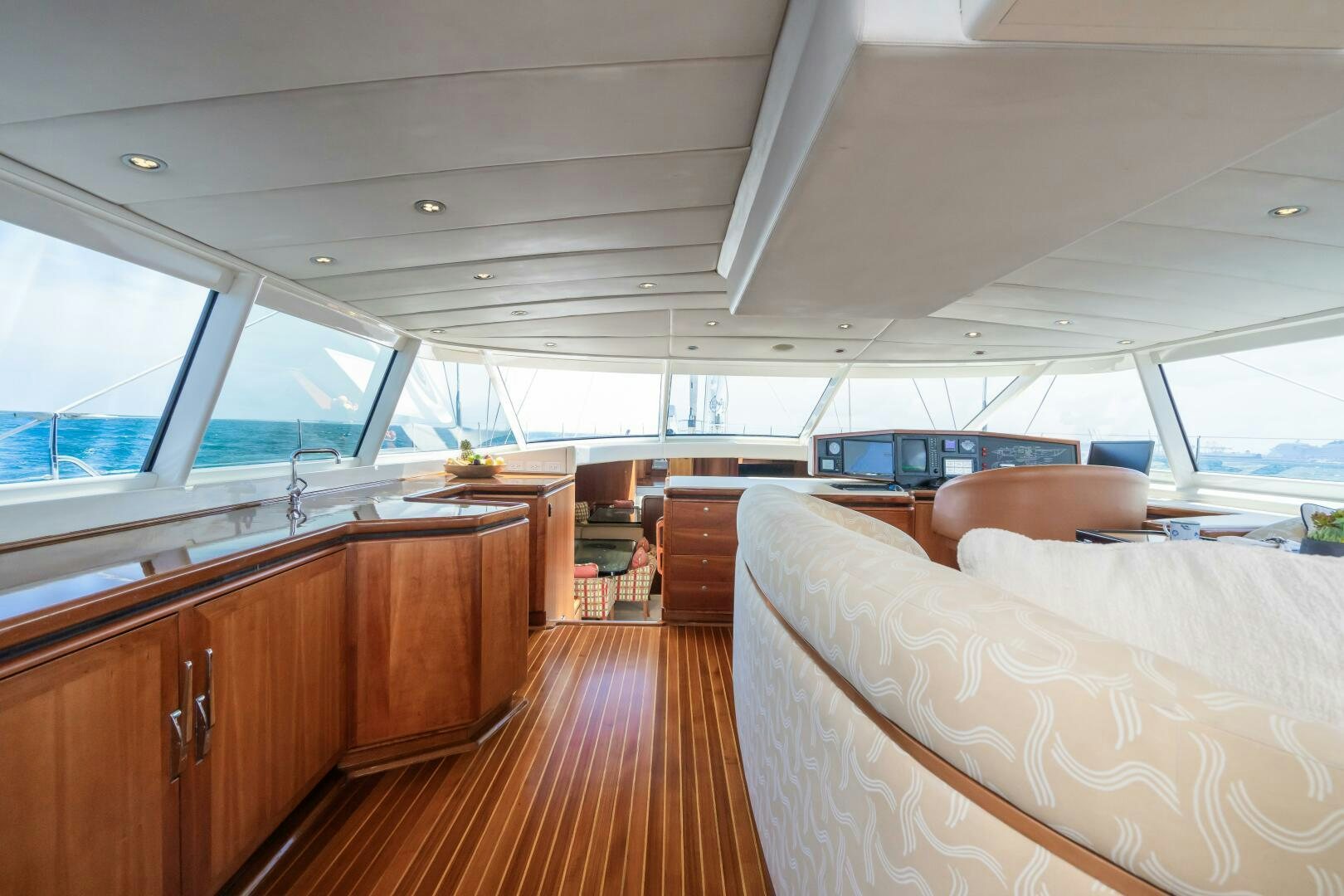 a room with a wood floor and a large window with a view of the ocean aboard SEAQUELL Yacht for Sale