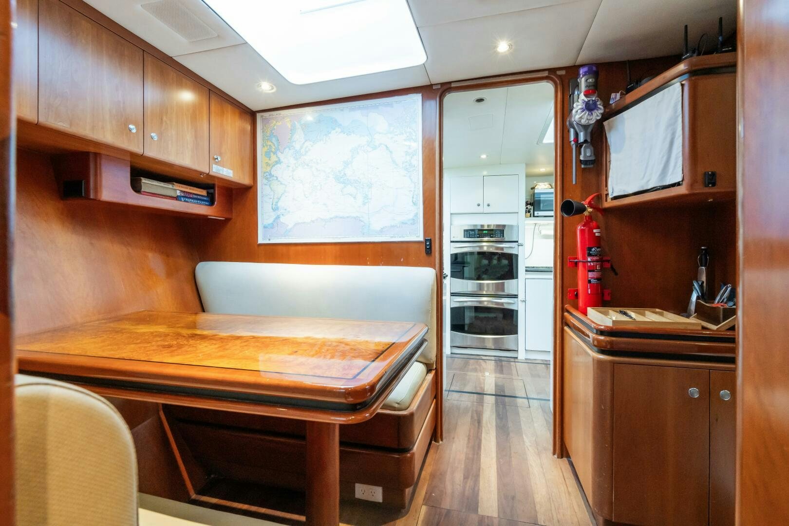 a kitchen with a table and cabinets aboard SEAQUELL Yacht for Sale