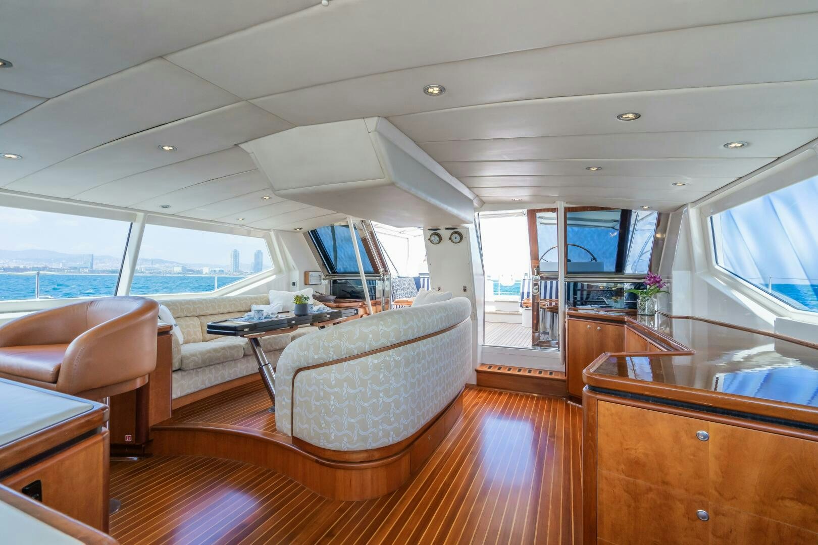 a living room with a large window aboard SEAQUELL Yacht for Sale