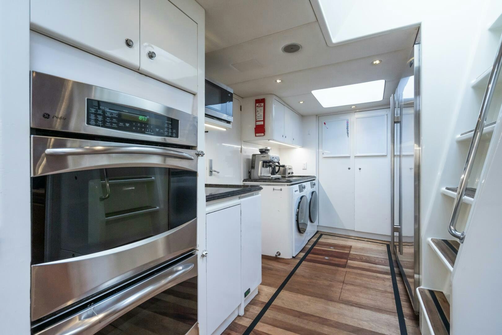 a kitchen with white cabinets aboard SEAQUELL Yacht for Sale