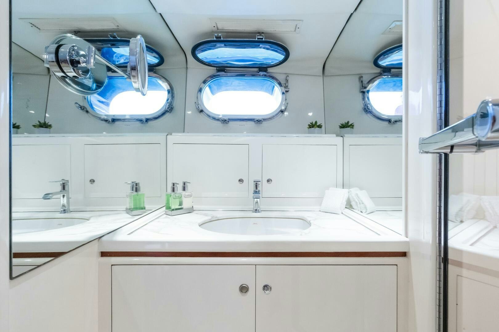 a bathroom with a sink and a large mirror aboard SEAQUELL Yacht for Sale
