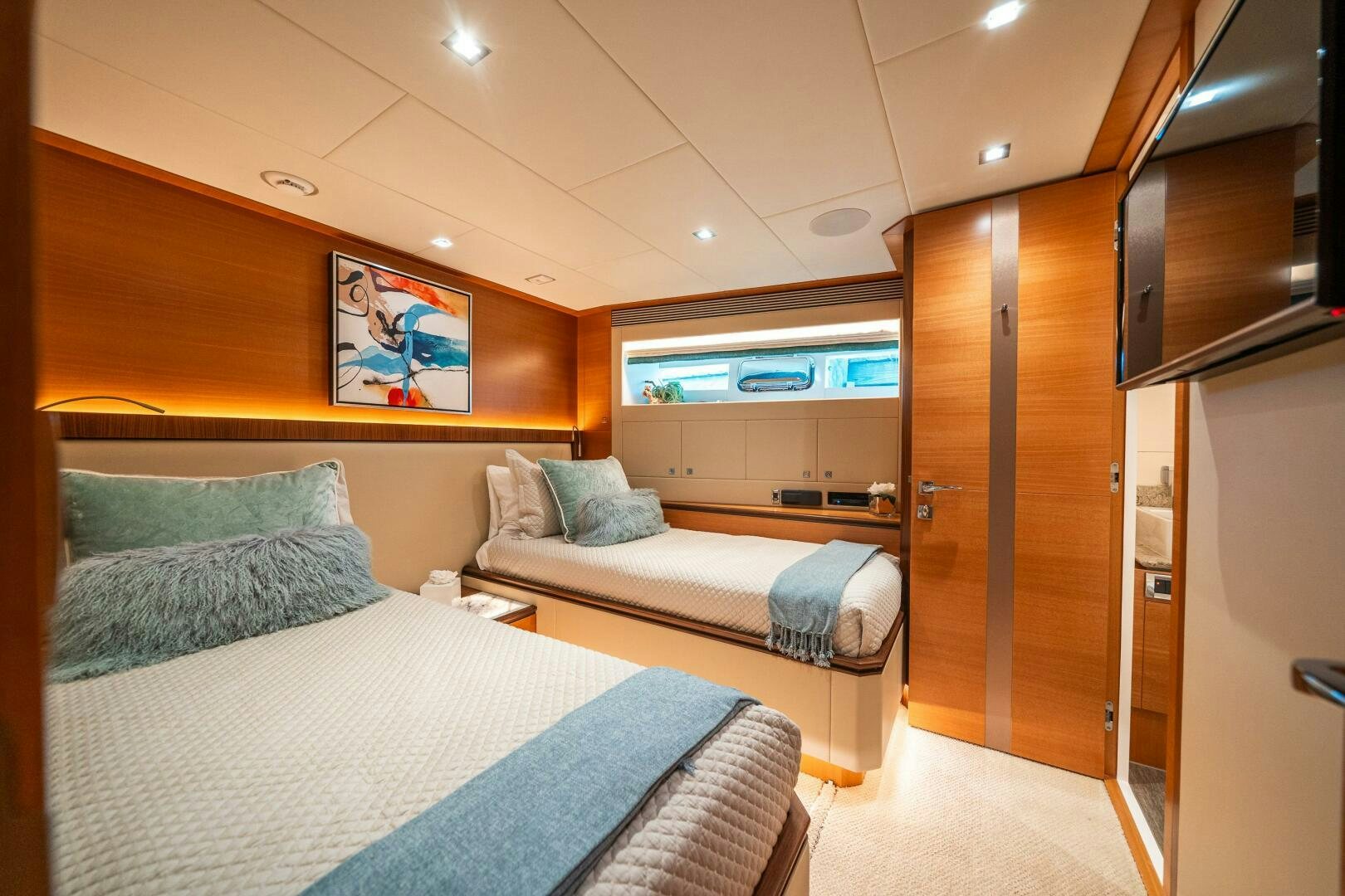 a room with a bed and a closet aboard MIDNIGHT MOON Yacht for Sale