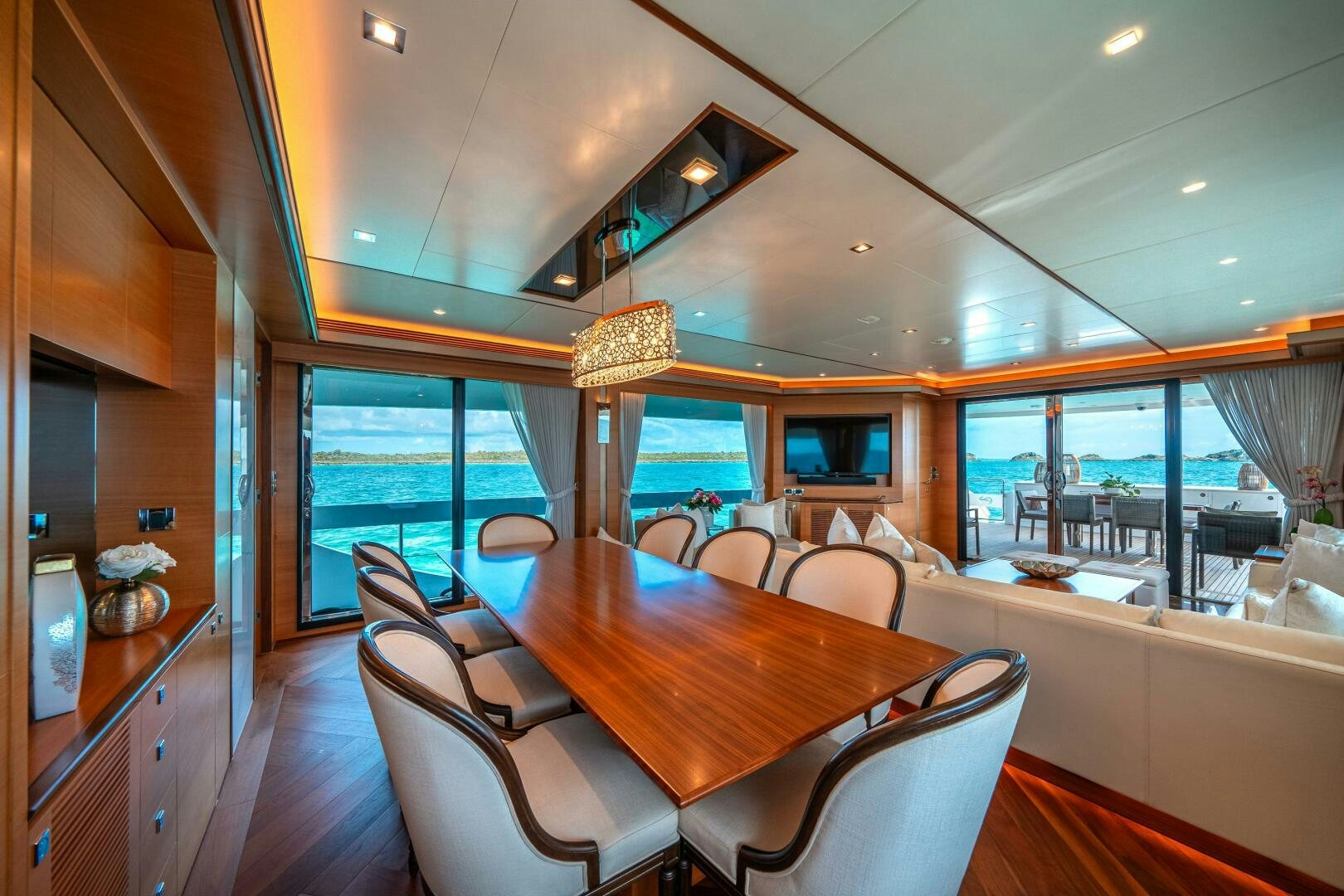 a dining room with a large window aboard MIDNIGHT MOON Yacht for Sale