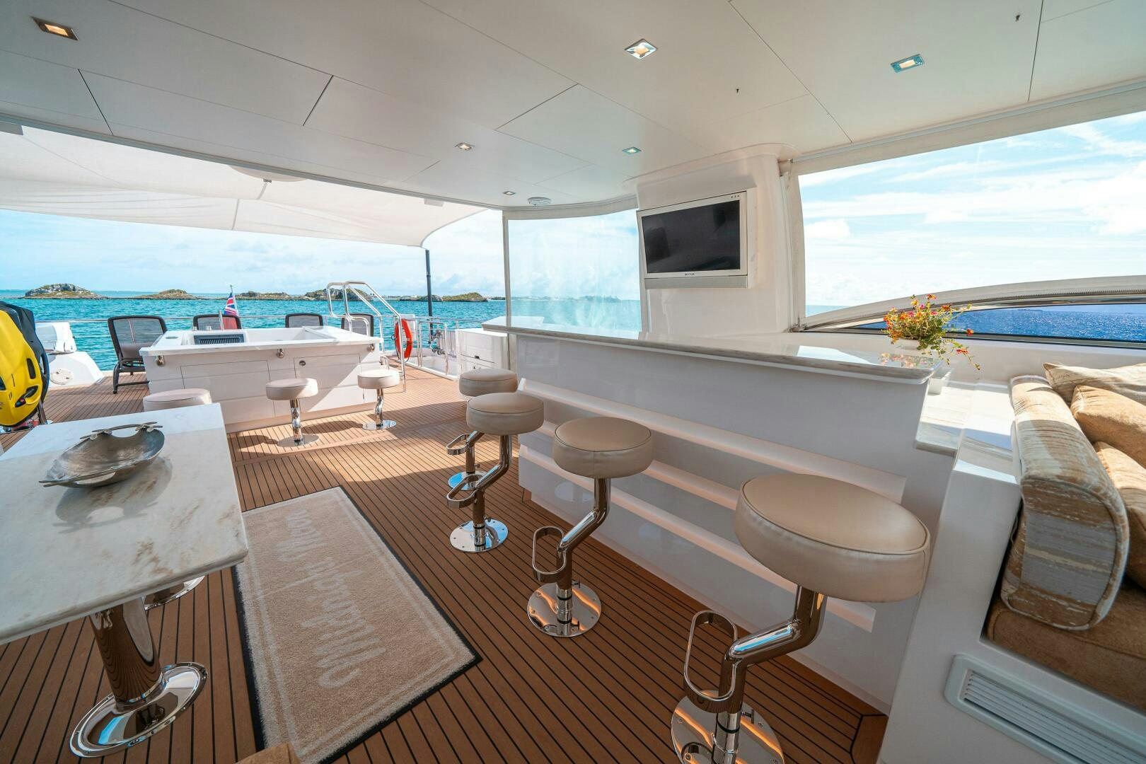 a room with a table chairs and a television aboard MIDNIGHT MOON Yacht for Sale