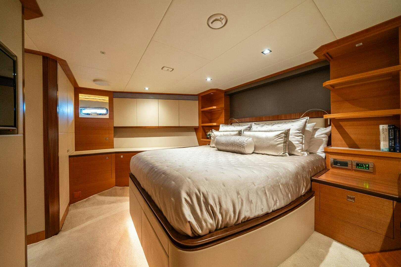 a bedroom with a bed and a dresser aboard MIDNIGHT MOON Yacht for Sale