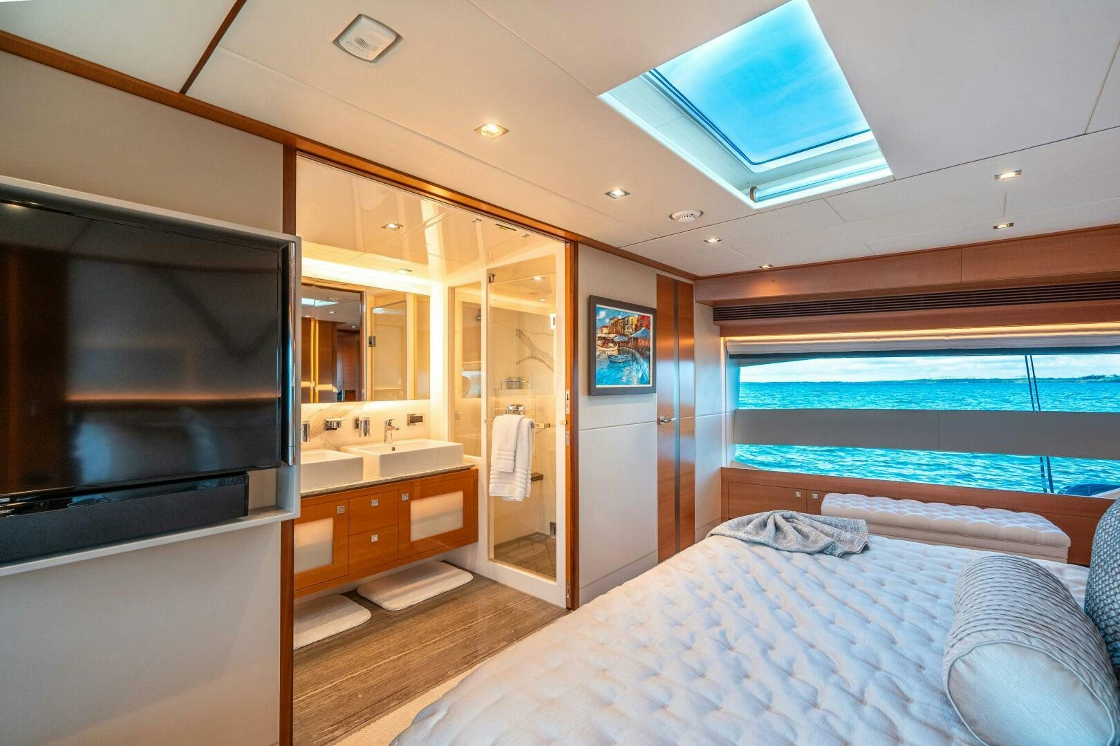 a bedroom with a bed and a television aboard MIDNIGHT MOON Yacht for Sale
