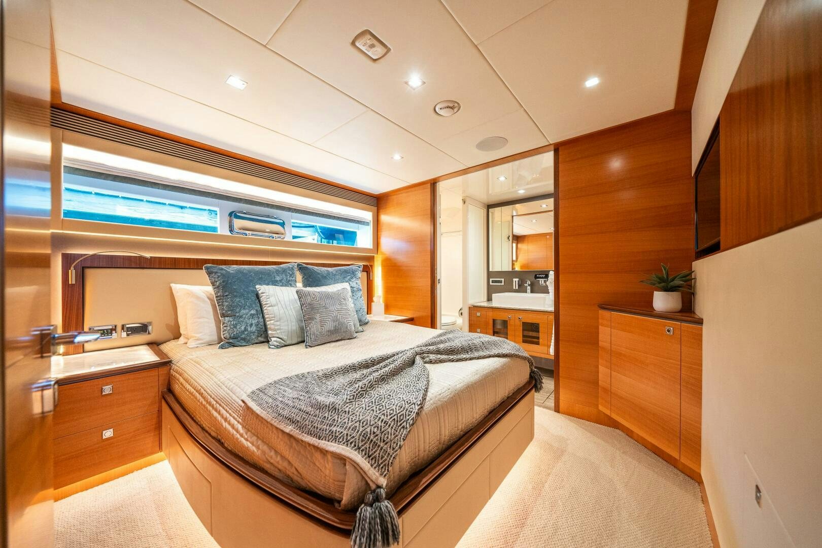 a bedroom with a bed and a window aboard MIDNIGHT MOON Yacht for Sale