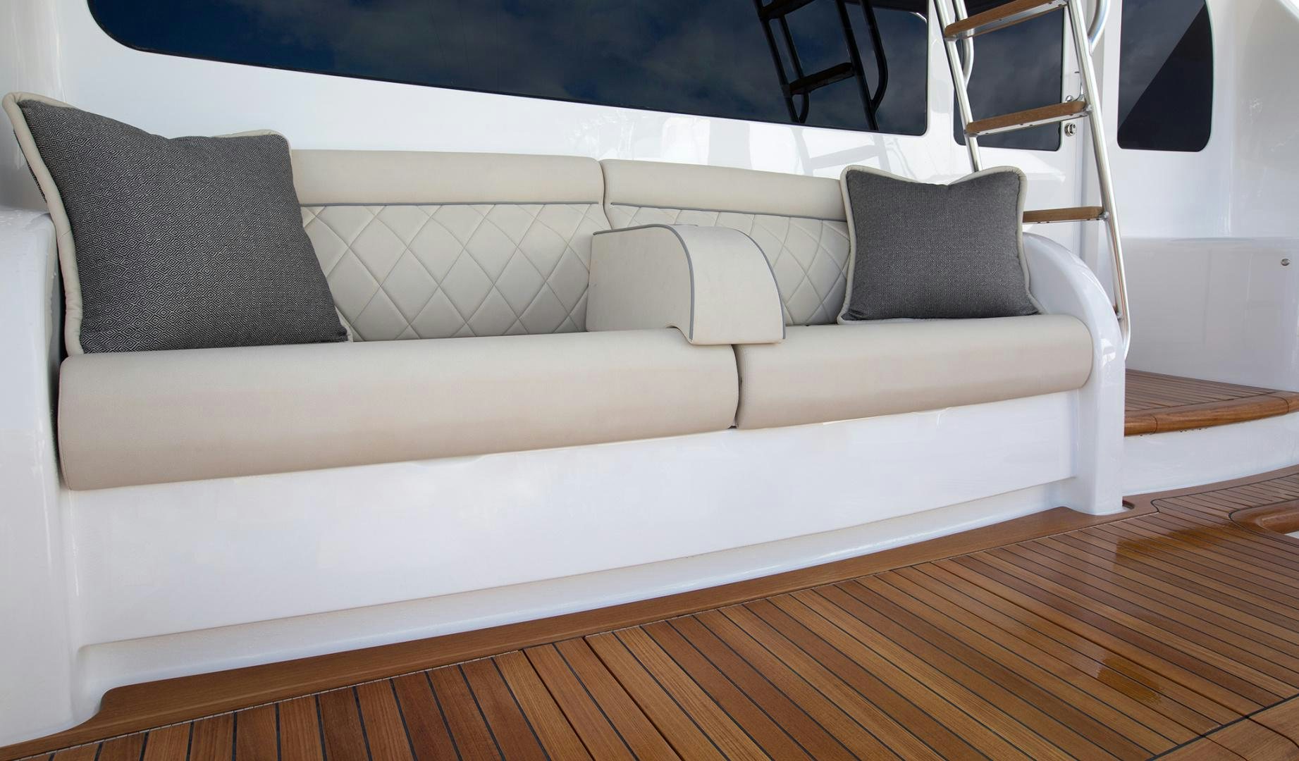 a white couch with pillows aboard NEW BUILD Yacht for Sale