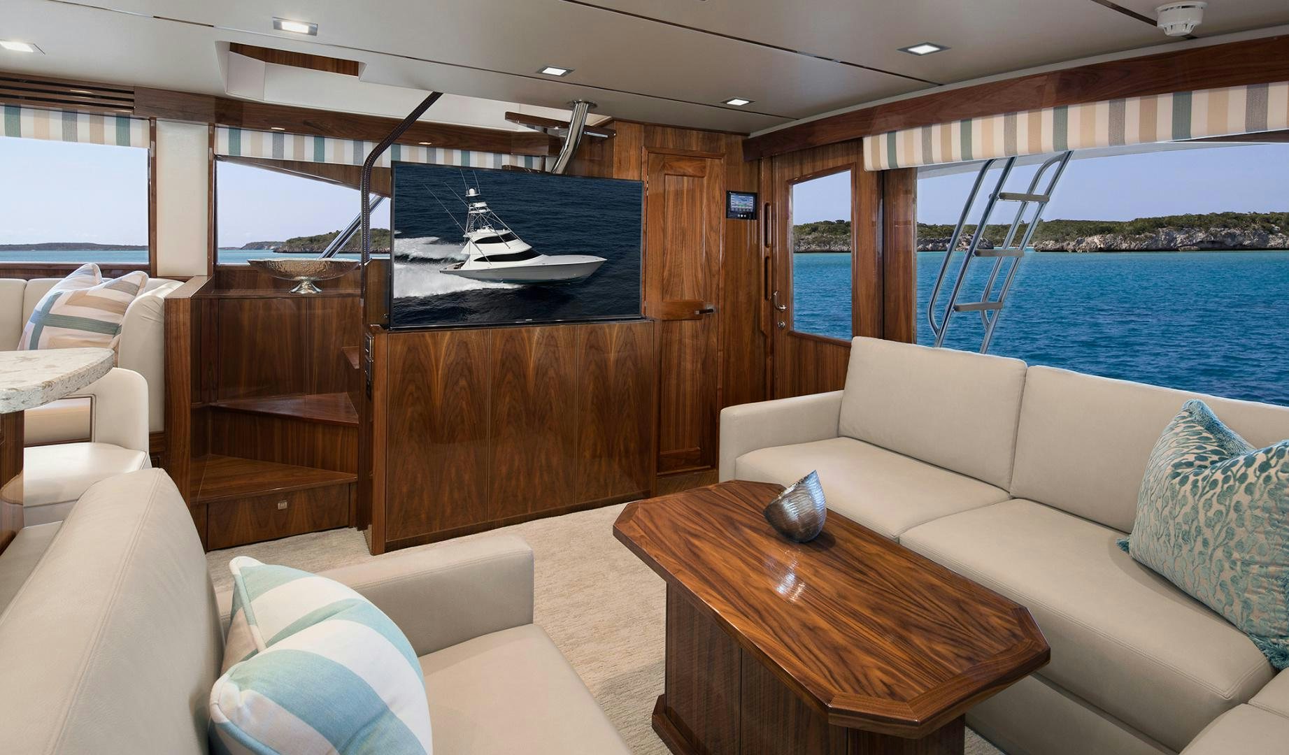 a living room with a large wood wall and a pool aboard NEW BUILD Yacht for Sale