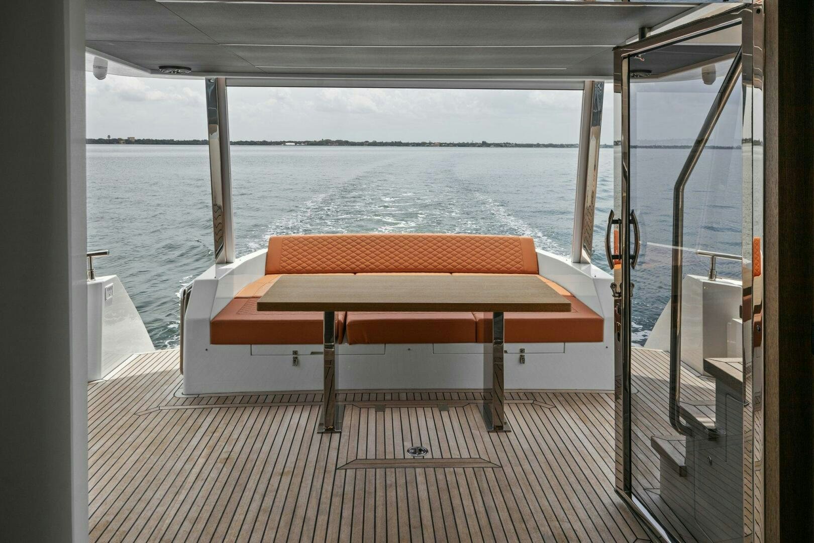 a table on a deck overlooking the ocean aboard TINKA BUNNY Yacht for Sale
