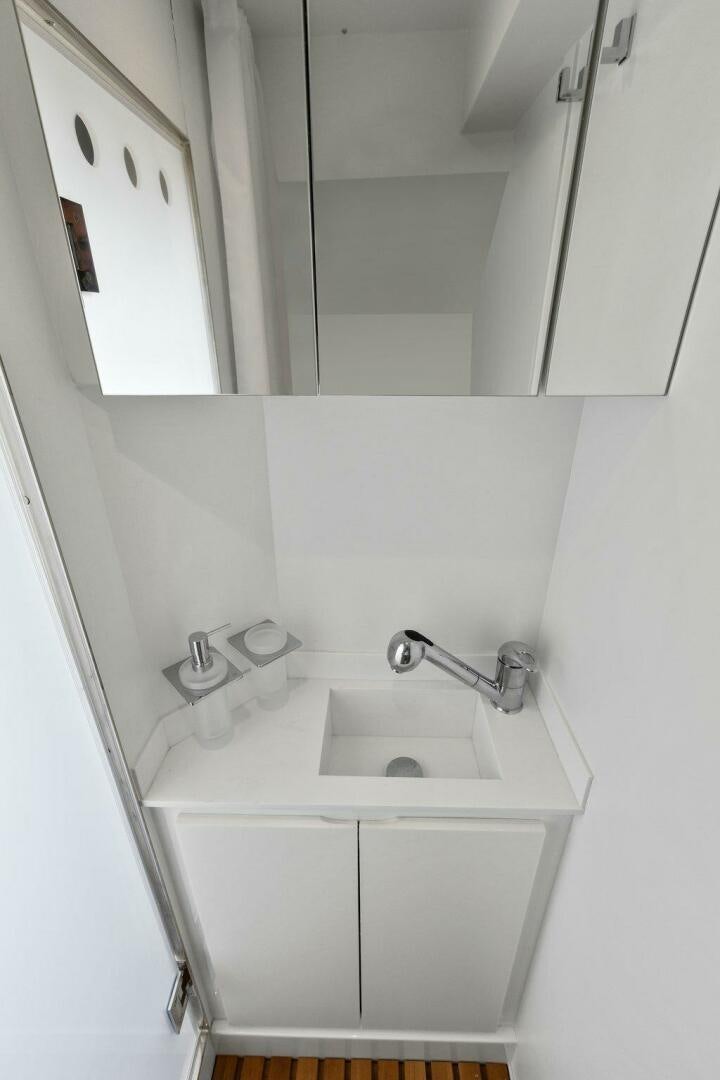 a bathroom with a sink and mirror aboard TINKA BUNNY Yacht for Sale