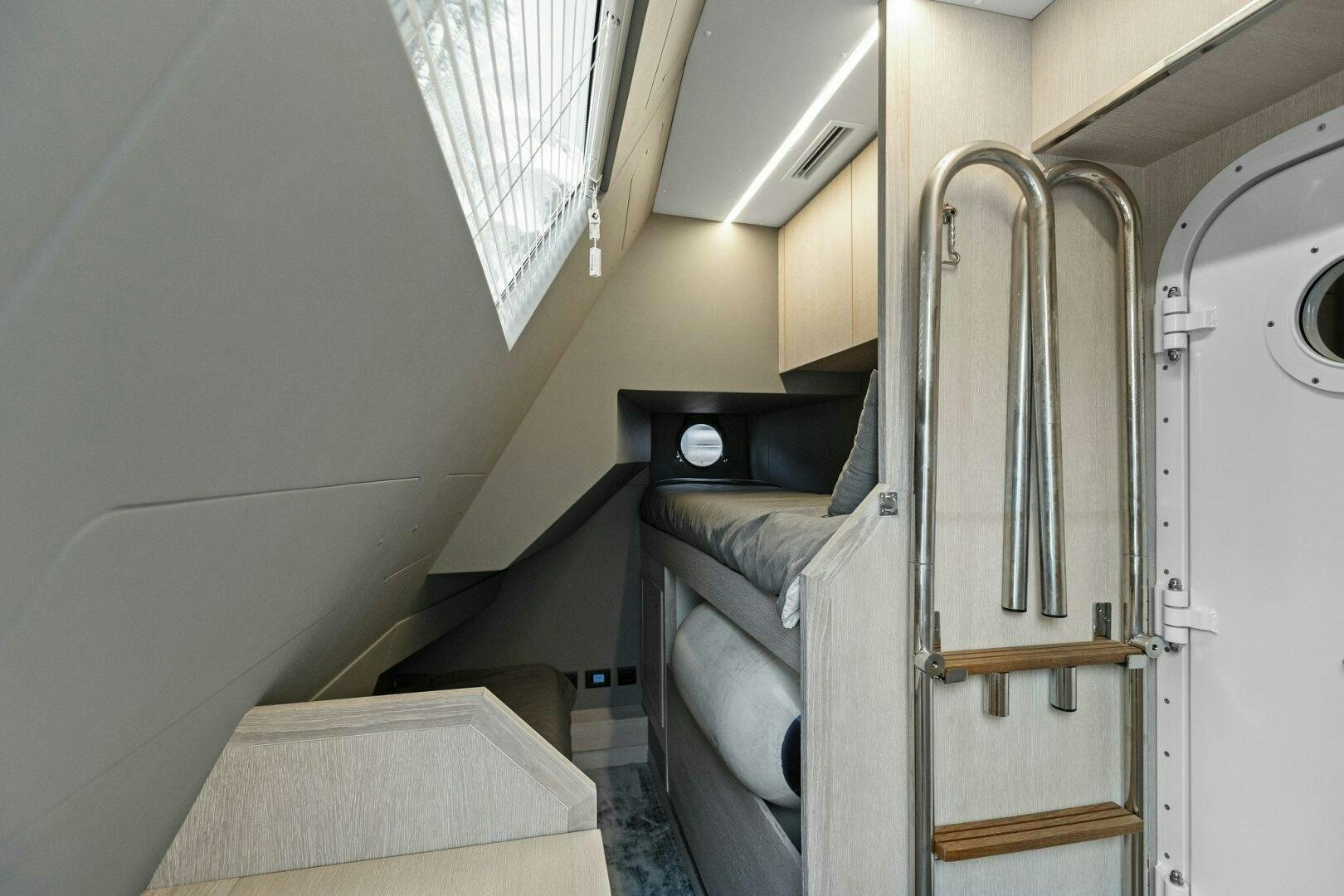 a room with a bed and a closet aboard TINKA BUNNY Yacht for Sale