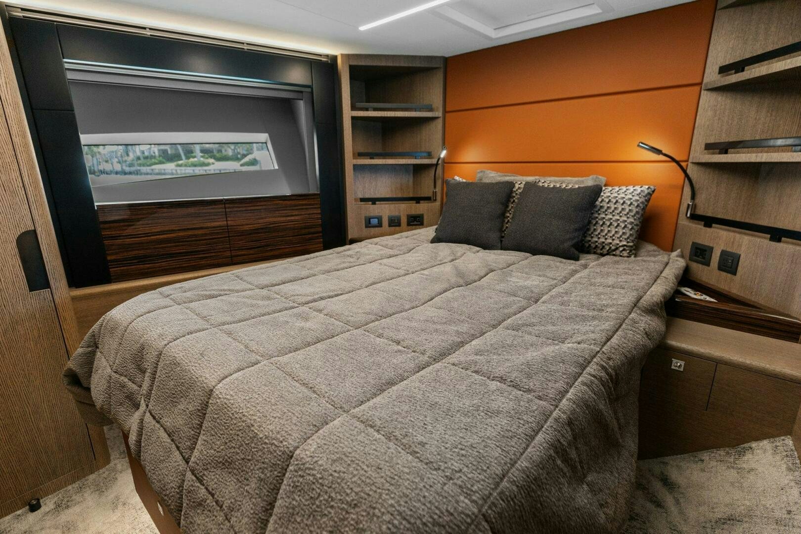 a bed with a black and white comforter and pillows aboard TINKA BUNNY Yacht for Sale