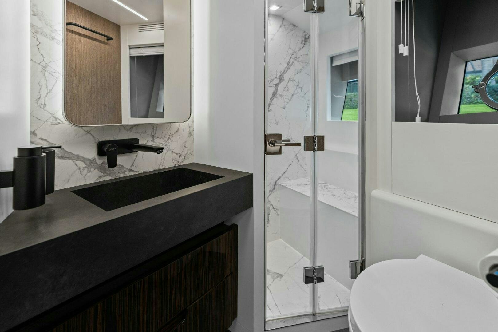 a bathroom with a glass shower aboard TINKA BUNNY Yacht for Sale