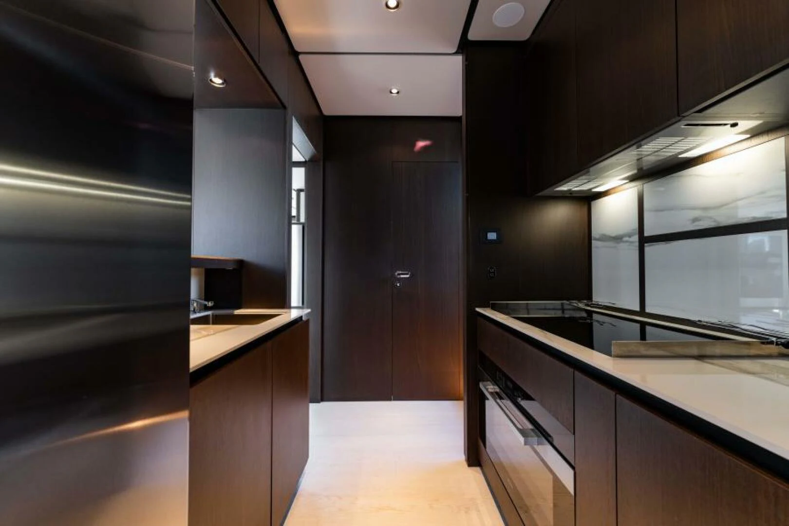 a kitchen with black cabinets aboard INEA Yacht for Sale