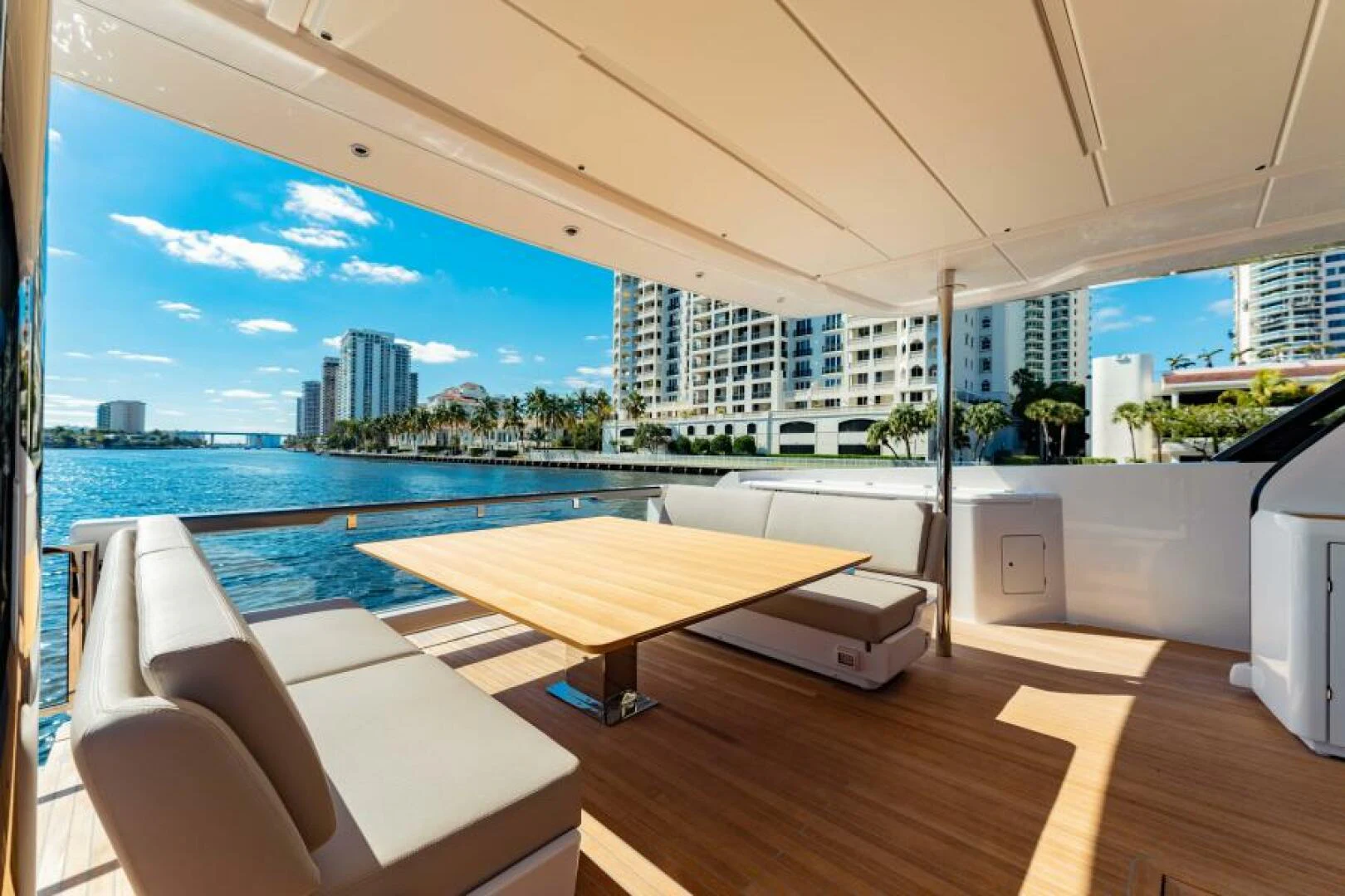 a room with a table and chairs and a large body of water aboard INEA Yacht for Sale