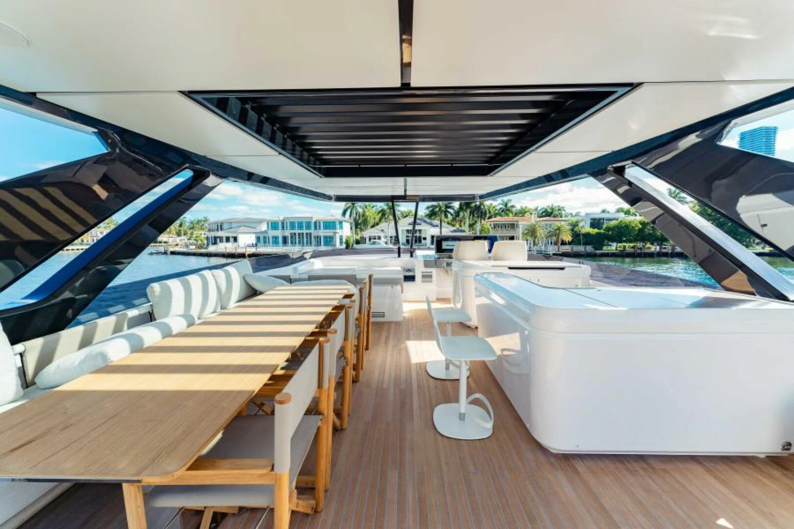 a deck with a pool and a deck with chairs aboard INEA Yacht for Sale