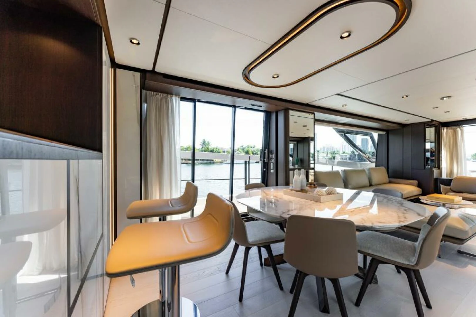a large room with a table and chairs aboard INEA Yacht for Sale
