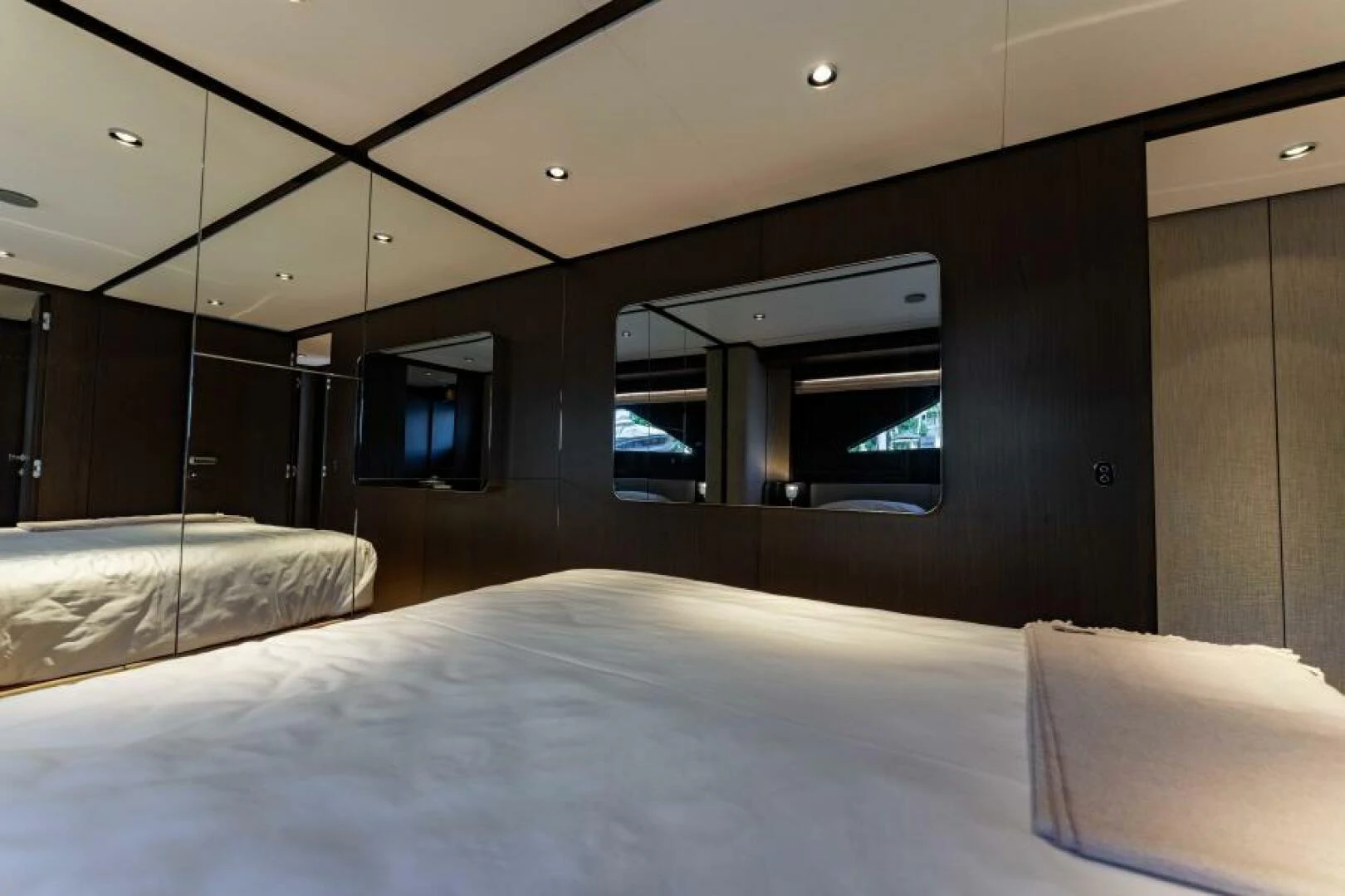 a room with a bed and a tv on the wall aboard INEA Yacht for Sale
