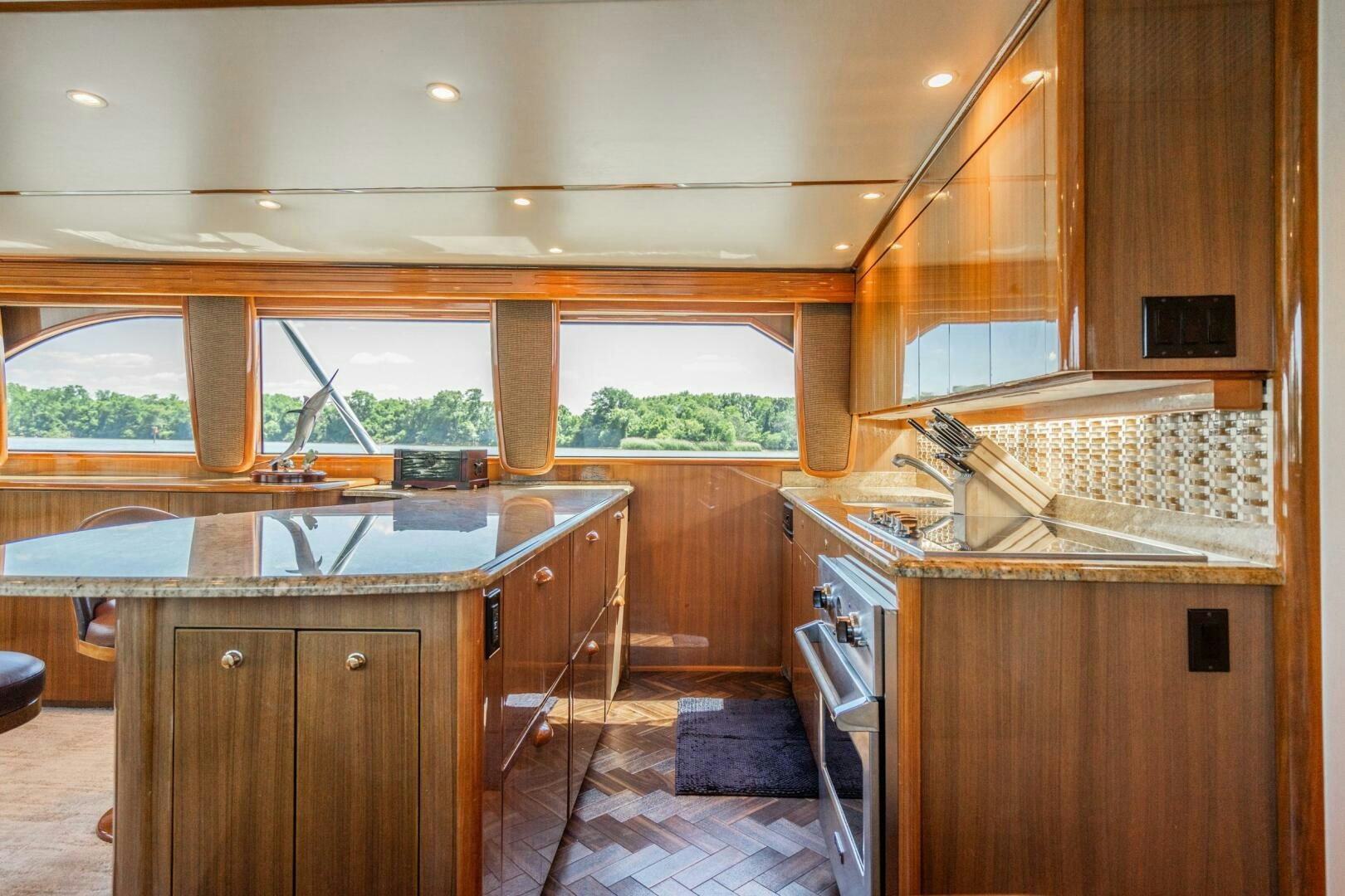 a kitchen with wooden cabinets aboard W Yacht for Sale