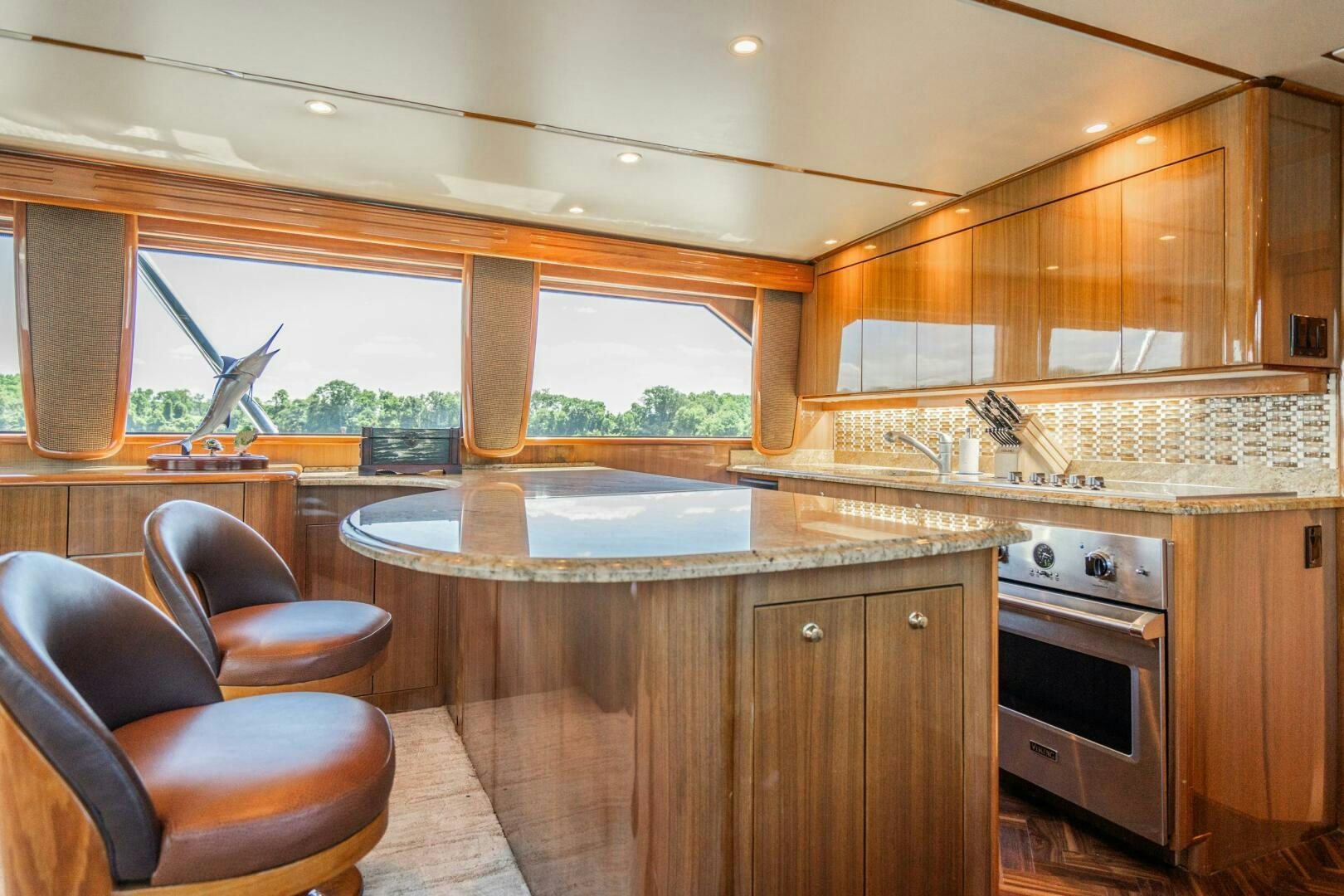 a kitchen with wooden cabinets aboard W Yacht for Sale