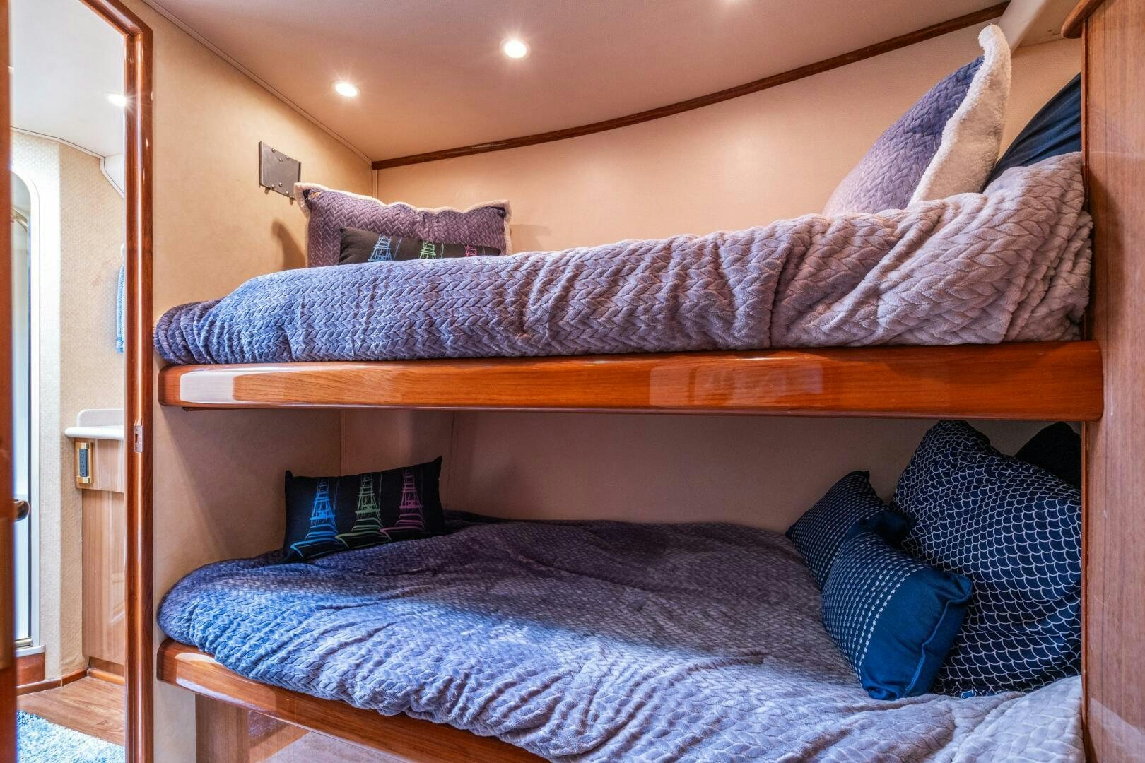 a bed with blue pillows aboard W Yacht for Sale