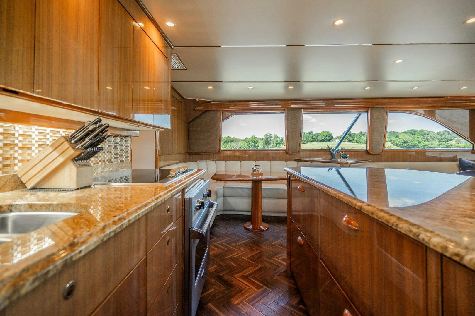 a kitchen with wooden cabinets aboard W Yacht for Sale