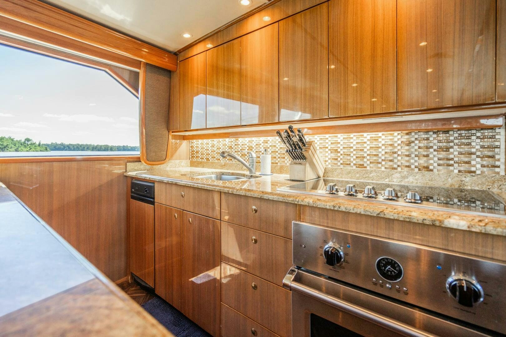 a kitchen with wooden cabinets aboard W Yacht for Sale