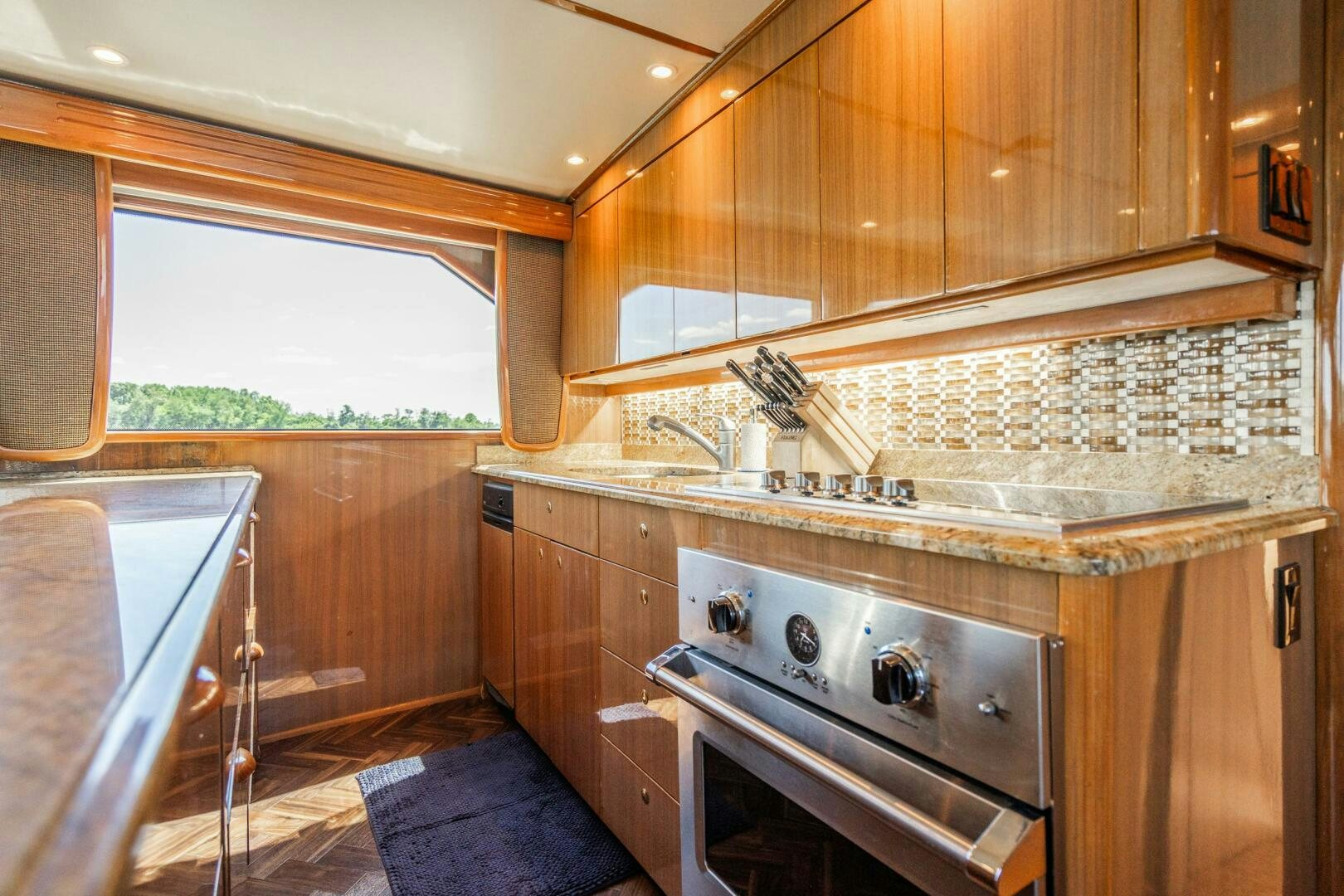 a kitchen with wooden cabinets aboard W Yacht for Sale