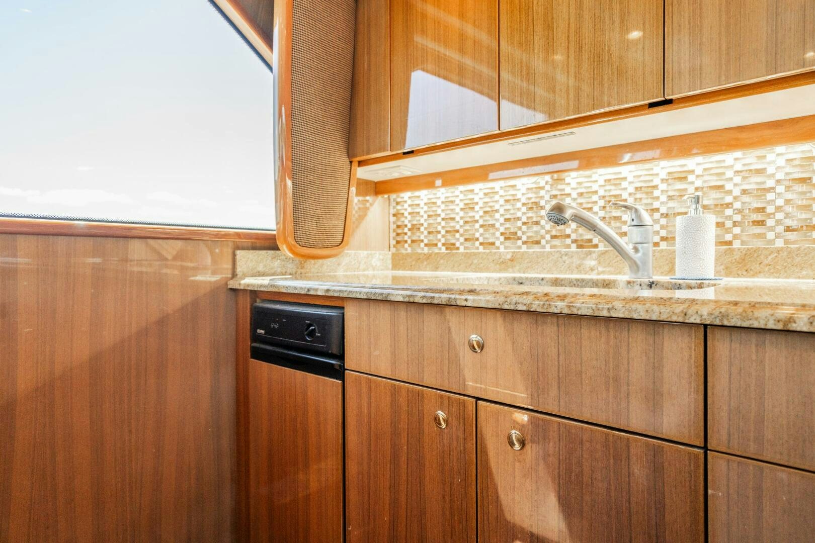 a kitchen with wooden cabinets aboard W Yacht for Sale