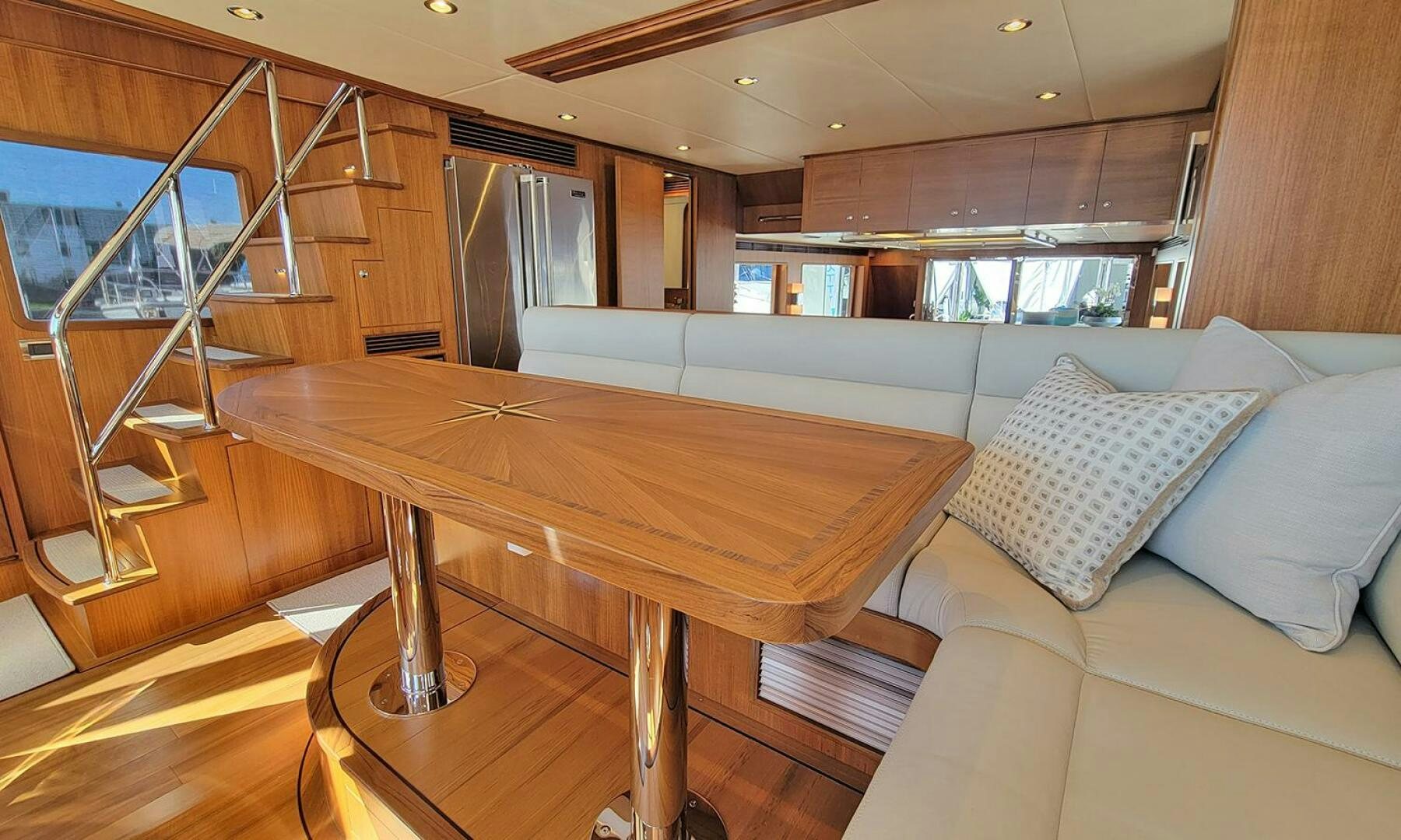 a room with a table and couch aboard OKIE Yacht for Sale