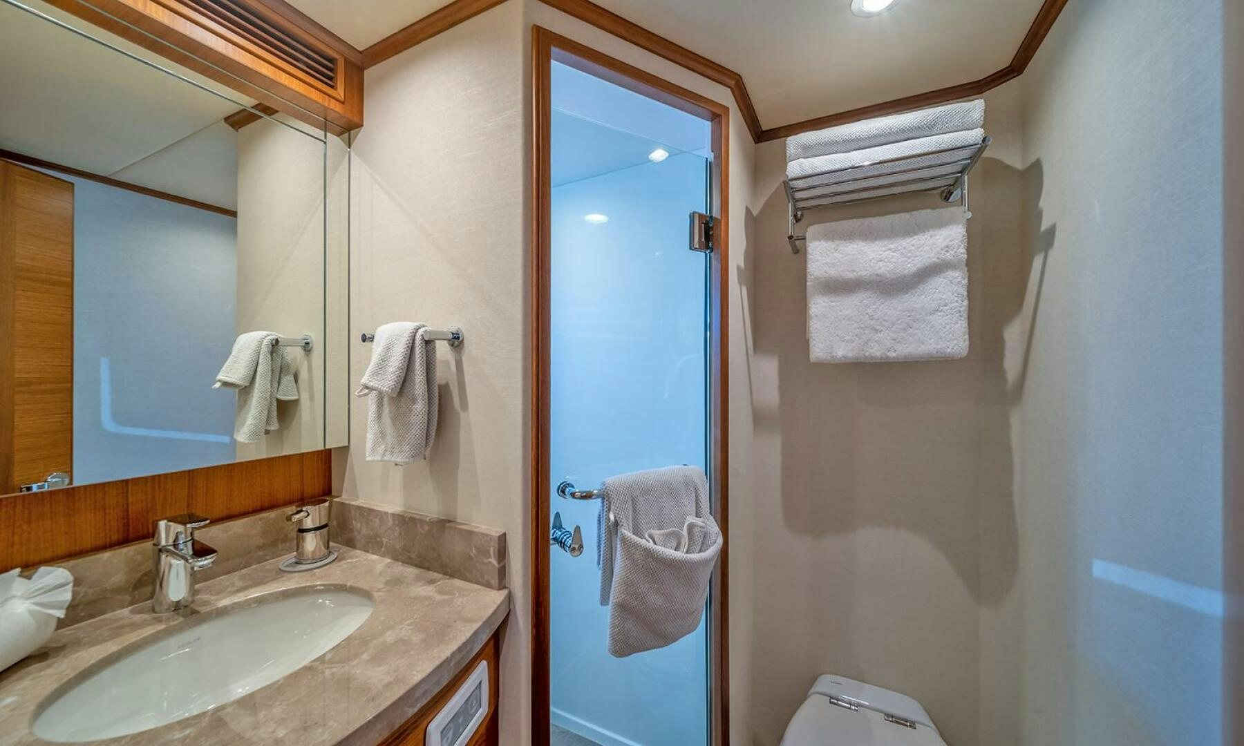 a bathroom with a sink and towels aboard OKIE Yacht for Sale