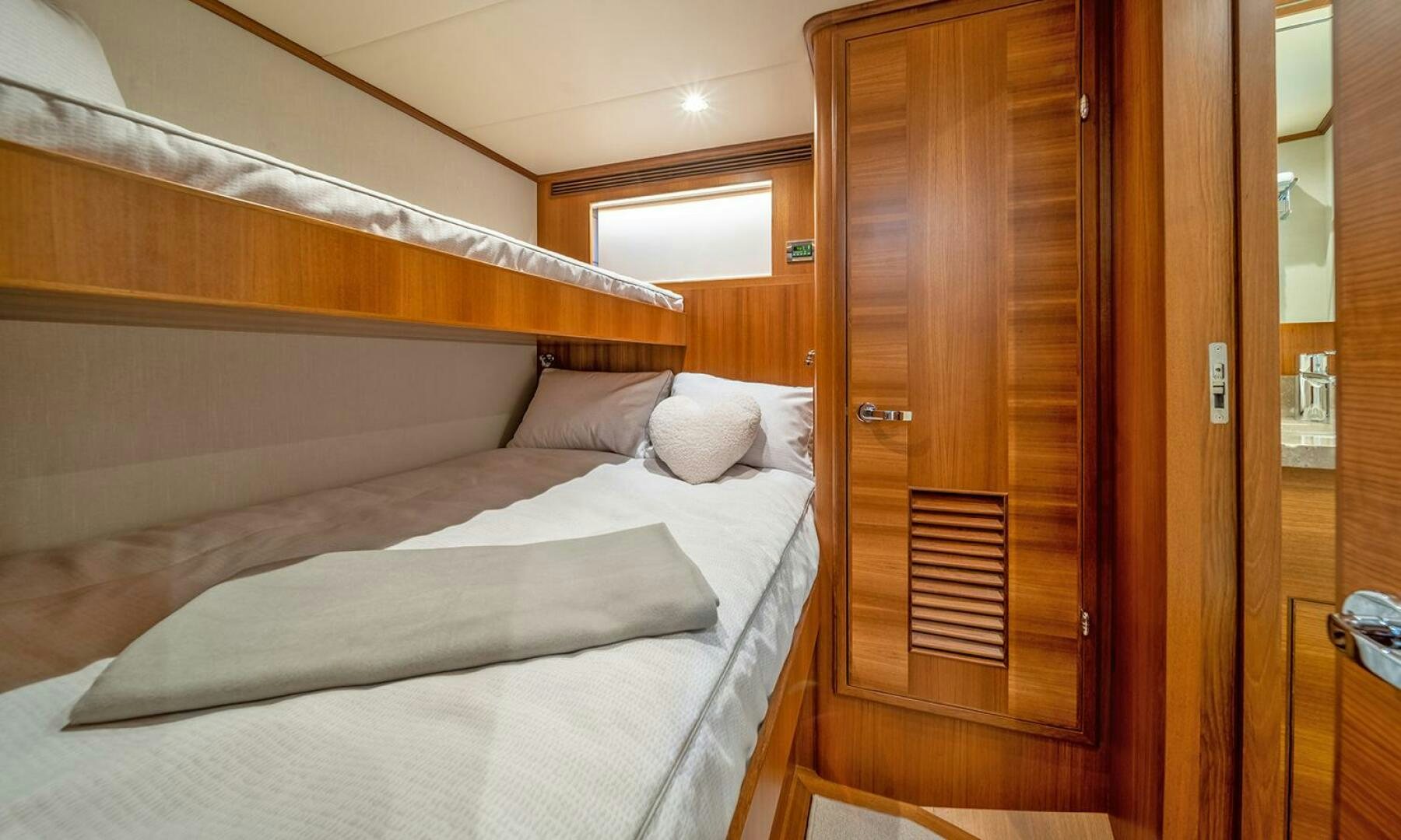 a bed with a wooden door aboard OKIE Yacht for Sale