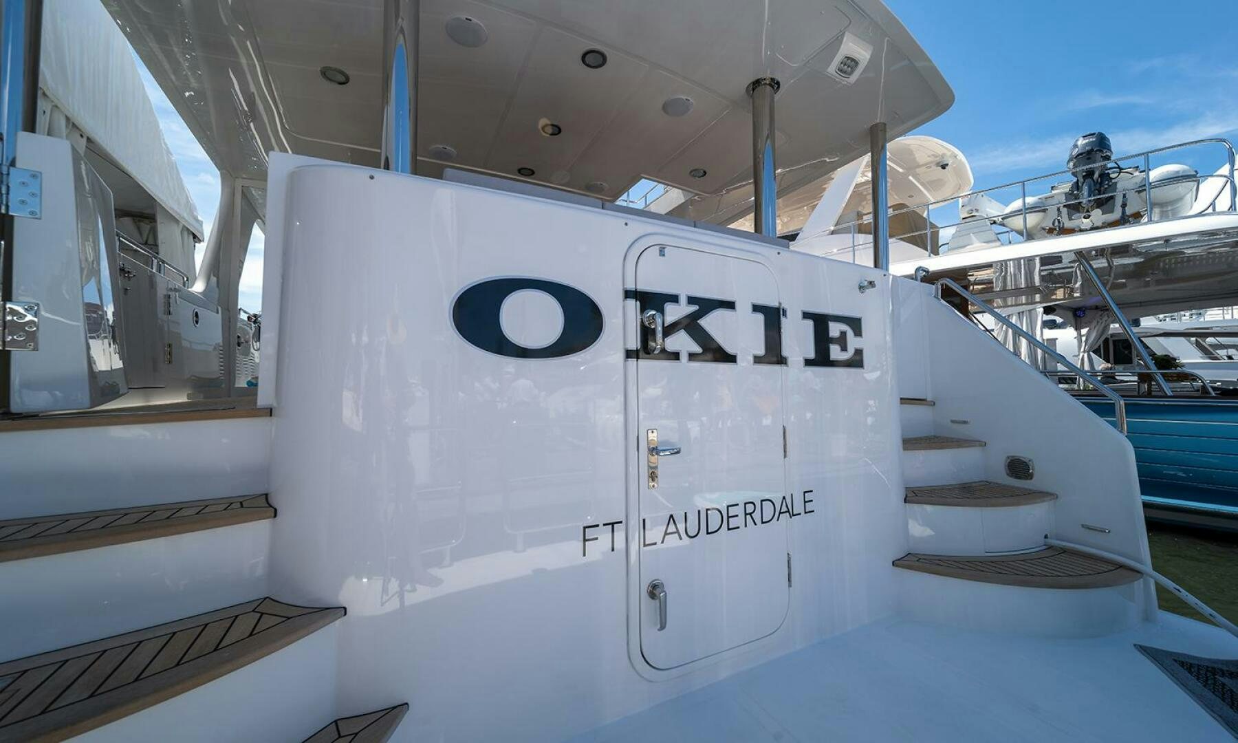 a white boat on a dock aboard OKIE Yacht for Sale