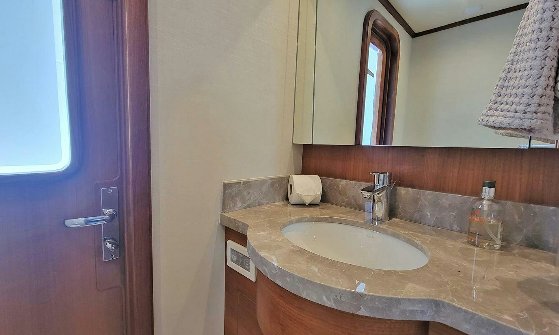a bathroom with a sink and a mirror aboard OKIE Yacht for Sale
