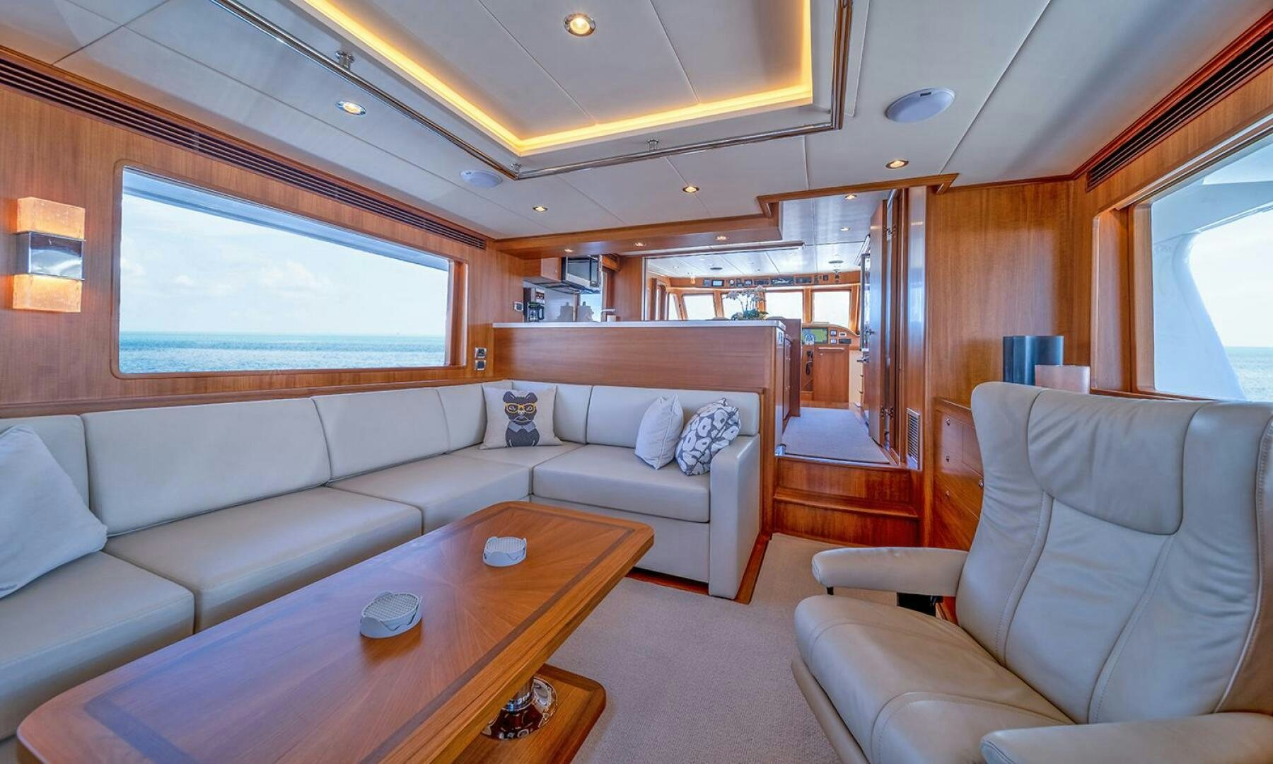 a living room with a table and couches aboard OKIE Yacht for Sale