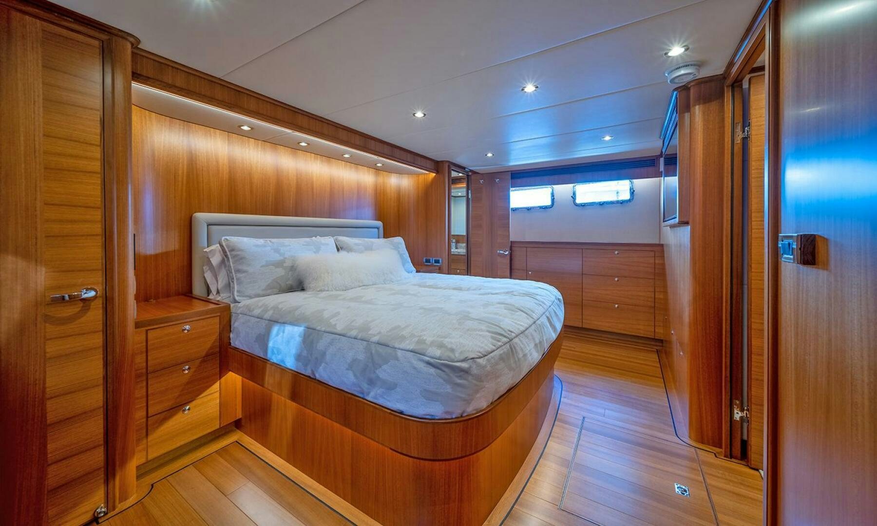 a bedroom with a bed and a closet aboard OKIE Yacht for Sale