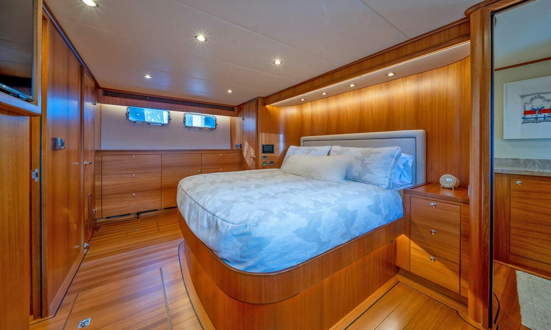 a bedroom with a bed and a closet aboard OKIE Yacht for Sale