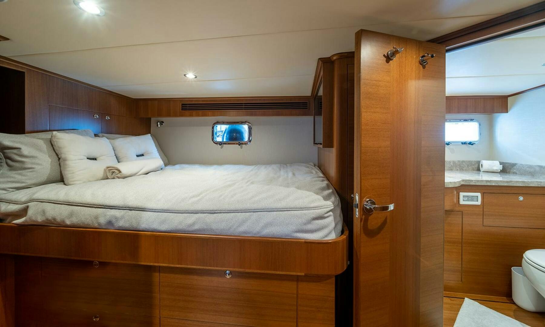 a bed with a wooden headboard aboard OKIE Yacht for Sale