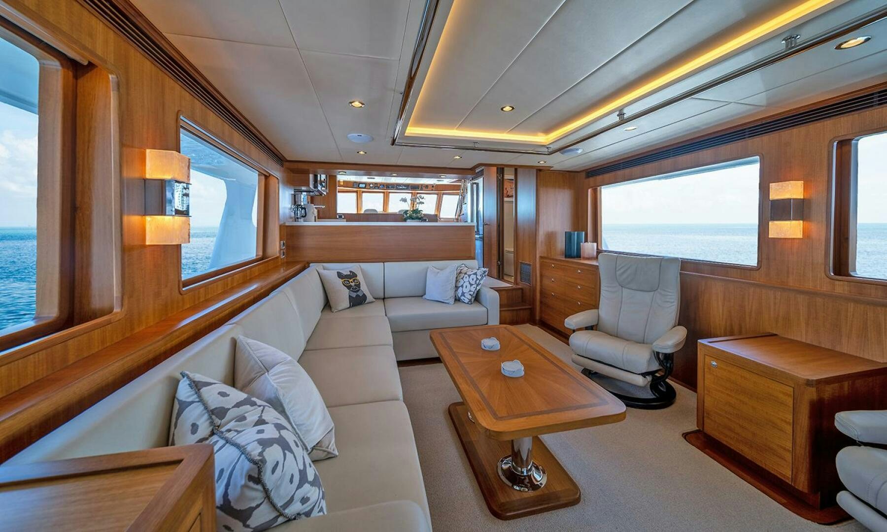 a living room with a couch and a coffee table aboard OKIE Yacht for Sale