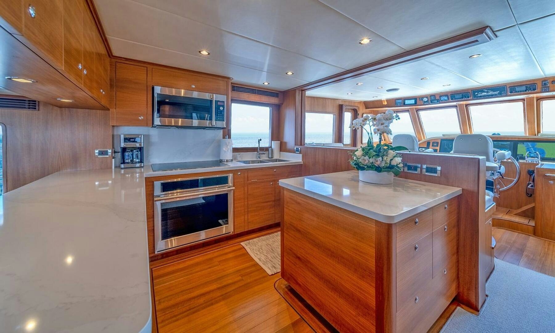 a kitchen with wooden cabinets aboard OKIE Yacht for Sale